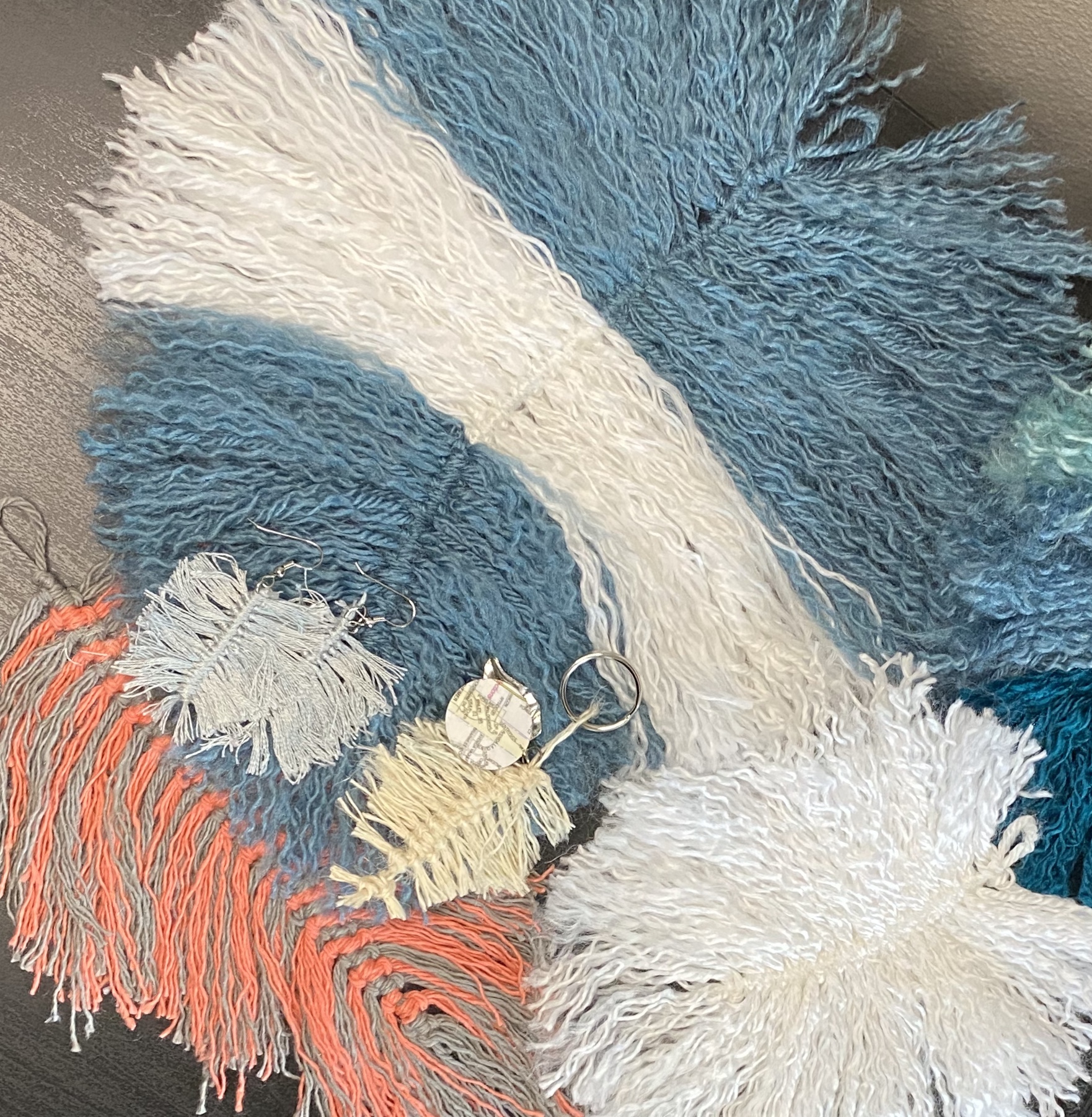 Five sample macrame feather projects using acrylic yarn, emroidery floss, jute, and cotton yarn.
