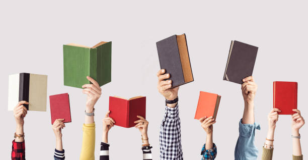 Picture of hands holding up books.
