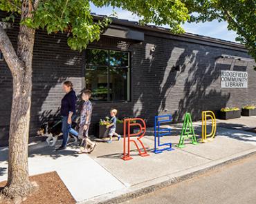 Children walking along Ridgefield Community Library's "READ" bike rack