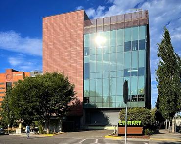 Th sun reflects back from the western wall of Vancouver Community Library