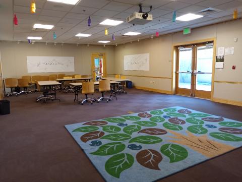 Meeting room with doors to outside and Children's area visible