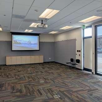 Large, empty meeting room with projection screen