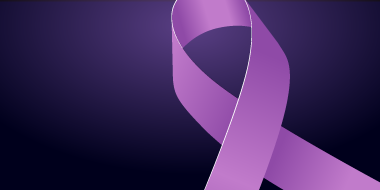 Purple ribbon in a loop on black background