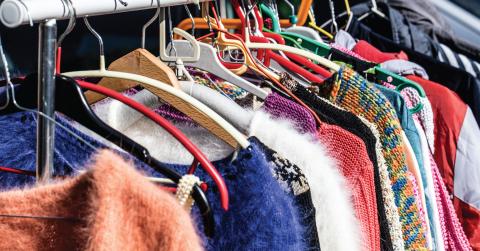 image of various clothing on hangers hung on a rack