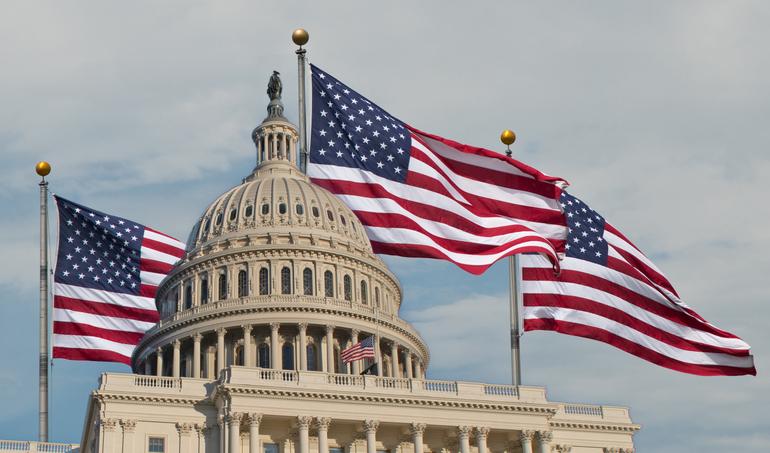 Capitol building with waving flags